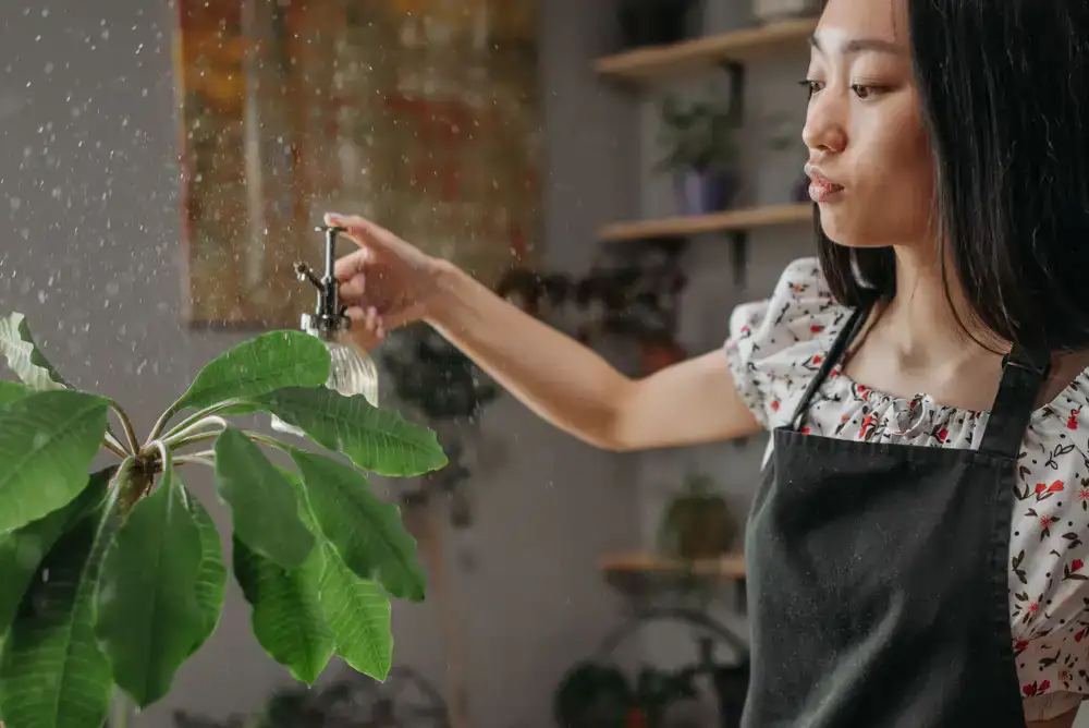 Botanist inspecting a plant leaf in a well-lit room