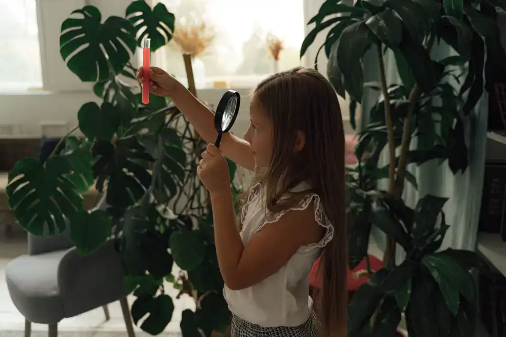 Botanist closely examining a large variegated plant leaf in a bright clinical setting